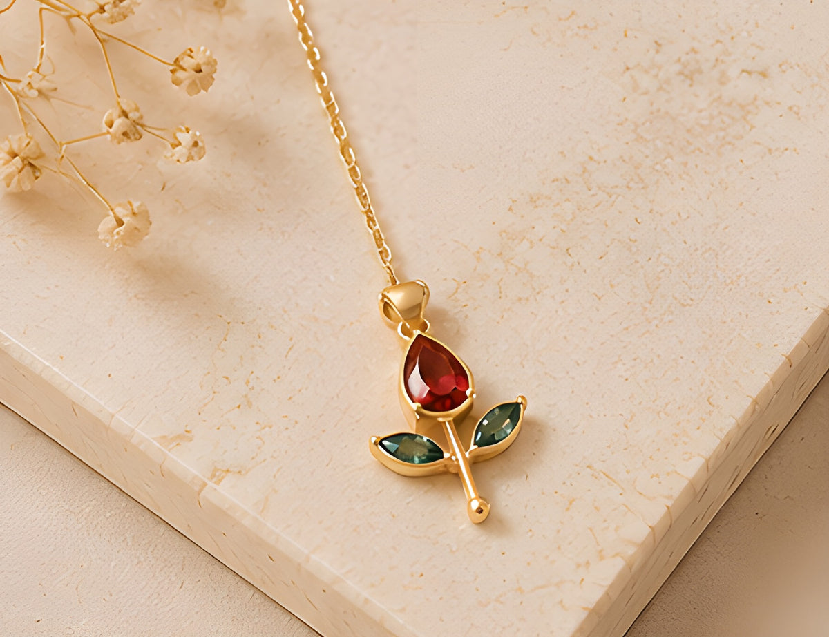 Close-up of the Vioras red tulip pendant with emerald-green leaves