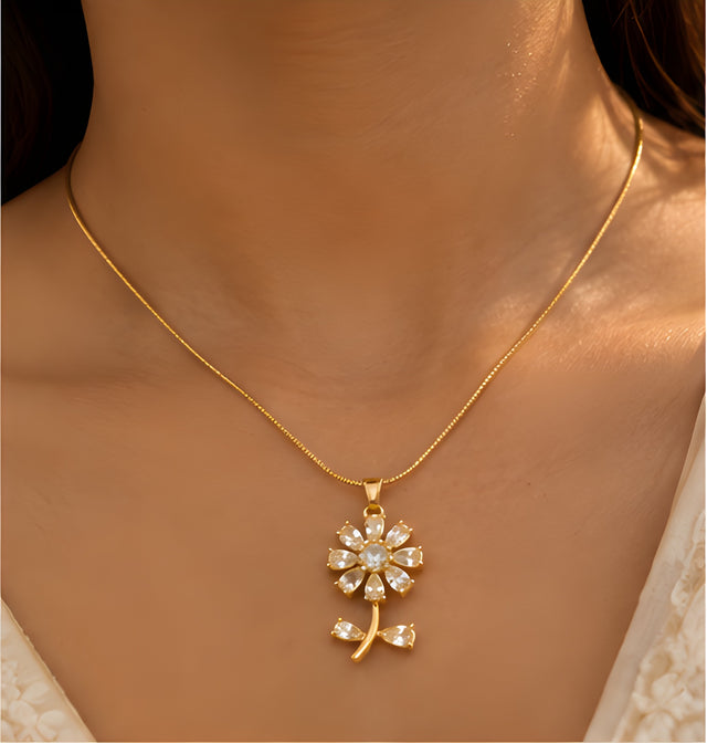 Vioras Crystal Blossom Pendant in gold worn on neckline