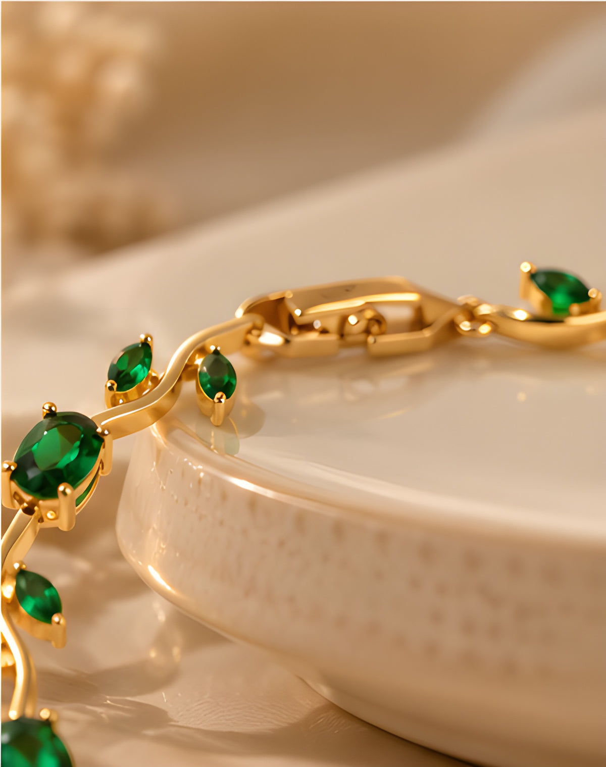 Vioras emerald green vine tulip bracelet detail styled near ceramic dish