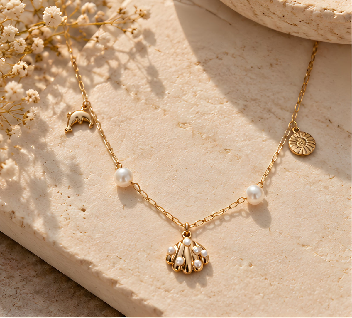 Vioras Ocean Charm Pearl Necklace arranged on stone